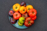 Fototapeta Tulipany - Bowl of colorful heirloom tomatoes in Provence, France