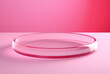 A clear round glass plate is on a pink background, styled with minimalist stage designs and rich layers.