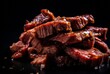 Beef strips are piled on a black surface.
