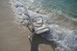 Ocean waves splashing over wet beach chair in tropical vacation resort