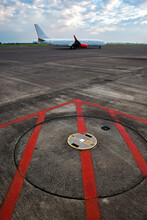 A Red Arrow Sign On The Airport Apron