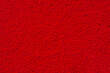 Brilliant red textured background. Backdrop with bright red abstract color. Texture and grain in blood red color.