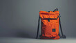 A orange backpack with the brand logo eacc on it, designed as a product shot in front of a grey background The bag is made from highquality leather and features multiple pockets