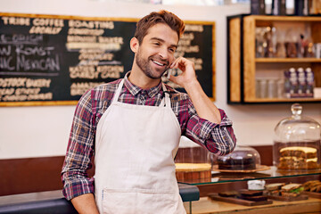 Poster - Man, coffee shop and cell phone call with smile for contact, deal or order for drink at small business. Person, barista or waiter with smartphone for conversation, networking and happy in cafeteria