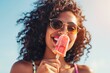 Young Woman Enjoying a Refreshing Ice Pop on a Sunny Beach Day