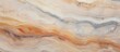 A closeup of a hardwood flooring with a swirl pattern resembling a marble texture. The natural material of the wood creates a beautiful and unique peachcolored pattern, resembling art and painting