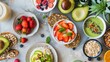 An array of healthy breakfast options featuring fresh fruits, oatmeal, smoothie, and avocado on a rustic surface.