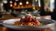 A contemporary twist on classic spaghetti and meatballs served on a stylish plate