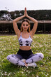 © Marino Bocelli - young charming blonde sporty woman in sportswear practicing yoga philosophy in a field of daisies