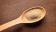 Quinoa in spoon with wooden textured
