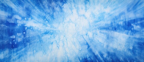 Wall Mural - A close up of a blue and white tie dye background resembling a natural landscape with cumulus clouds in an electric blue sky, creating a mesmerizing pattern