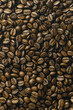 Background with close-up image capturing the rich, dark tones and intricate textures of roasted coffee beans. Ideal for projects related to coffee, beverages, or gourmet food