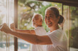© BrightSpace - Two senior women engaging in Thai boxing healthy lifestyle activities at the gym, A couple of older people are smiling and doing yoga together. Scene is happy and positive