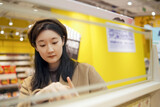 Fototapeta  - Young Woman Shopping for Groceries in Supermarket