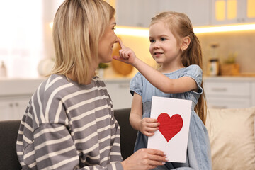 Sticker - Little daughter congratulating her mom with greeting card at home. Happy Mother's Day