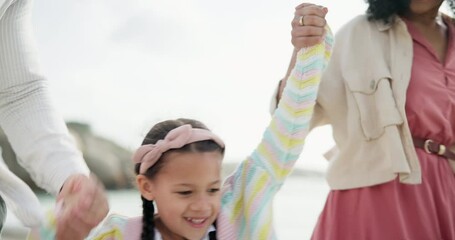 Wall Mural - Parents, swing and holding hands with girl by ocean with connection with care, love or bonding on holiday. Father, mother and daughter in summer with games, excited and playing at beach on vacation