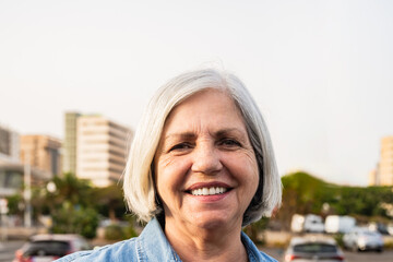 happy senior woman smiling in front of camera - elderly people lifestyle concept