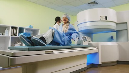 Sticker - Magnetic resonance imaging in the study of the human body. A doctor performs an MRI on a patient in the clinic. The girl lies in an MRI machine. Modern technologies in medicine.