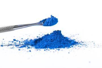 ultramarine pigment, dry paint on a white background, macro
