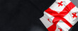 Flag of Georgia. Fabric textured Georgia flag isolated on dark background. 3D illustration