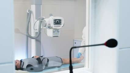 Sticker - A specialist radiologist doctor installs an x-ray scanner for a patient. Medical research, injury and treatment concept.