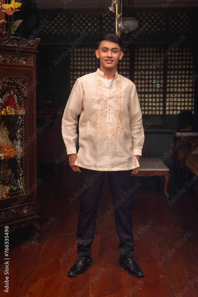 Full body photo of a young FIlipino man in traditional Barong Tagalog shirt and slacks, inside an ancestral house. Stock Photo | Adobe Stock Full body photo of a young FIlipino man in traditional Barong Tagalog shirt and slacks, inside an ancestral house. Stock Photo | Adobe Stock