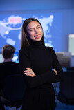 Fototapeta Sawanna - Smiling Confident Female Cybersecurity Analyst or Manager in large Cyber Security Operations Center SOC handling Threats