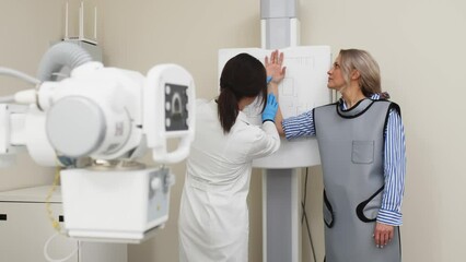 Wall Mural - Preparing for an x-ray of a young female patient. Examination of a broken or bruised arm. Medical examination, hospital trauma department.