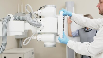 Wall Mural - Preparing for an x-ray of a young female patient. Examination of a broken or bruised arm. Medical examination, hospital trauma department.