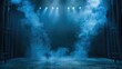 Theatrical stage engulfed by blue fog - The stage is dramatically revealed through intense blue lighting and a thick fog, setting a theatrical mood