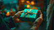 Two individuals share gifts and a blue box, their soft edges and blurred details contrasting with the dark orange and emerald colors.