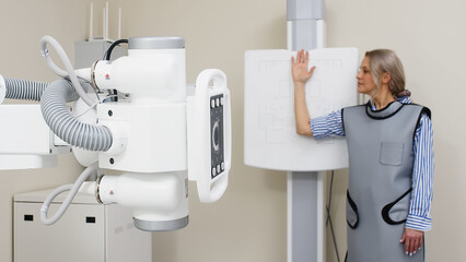 Wall Mural - Preparing for an x-ray of a young female patient. Examination of a broken or bruised arm. Medical examination, hospital trauma department.