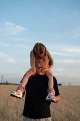 Wall Mural - Daughter sits on her father's shoulders 