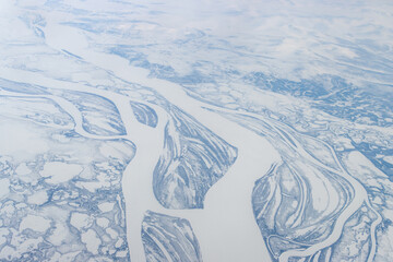 Wall Mural - Winter aerial photograph of the Kolyma River. An aerial view of the islands and ice-covered channels of a wide Siberian river. Republic of Sakha (Yakutia), Far North of Russia. Polar region, Arctic.