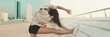 © Andrii Nekrasov - Asian girl in sportswear does workout, stretching and gymnastics on modern buildings background, Panorama