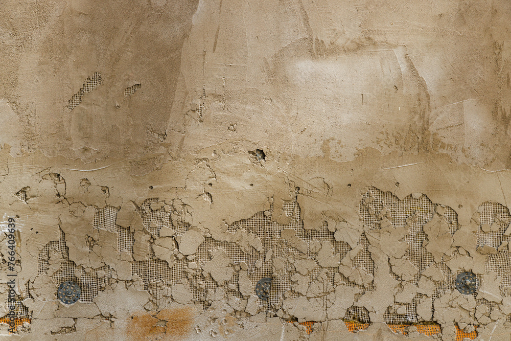 cheap plaster peeled off, revealing mesh layer - full-frame background ...