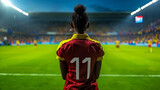 Fototapeta Sport - Soccer Player Number 11 Observing Stadium Game at Dusk