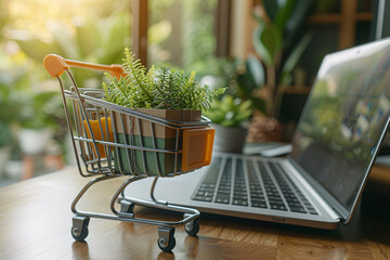 Wall Mural - A laptop computer and a shopping cart with a green plant and parcel box inside, ecommerce concept