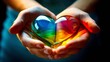 Hands holding a rainbow-colored heart, symbolize social responsibility