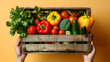 Hands holding wooden box filled with colorful vegetables