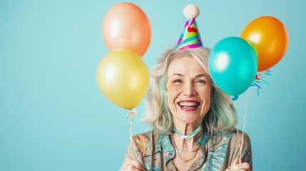 Wall Mural - senior wrinkled woman, celebrates birthday wears festive clothes isolated over pink background