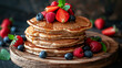 Stack of pancakes with berries and syrup