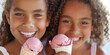 Pair of girls of African American descent eating ice cream