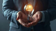 Macro shot of a businessman's hands presenting a glowing brain-infused light bulb, signifying the intellect and creativity driving successful business ventures