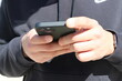 © Dakota B. Oldeman - Digital Connection: Hands Engaged with Smartphone