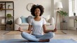 © AdriFerrer - Young African American female in serene meditation pose, relaxed at home.