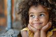 A cheerful mixed race child with a beaming smile and eyes full of hope represents a blend of cultures, perfect for celebrating happiness, joy and African American heritage.