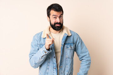 Wall Mural - Caucasian man with beard over isolated background frustrated and pointing to the front
