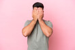 Young caucasian handsome man isolated on pink background covering eyes by hands