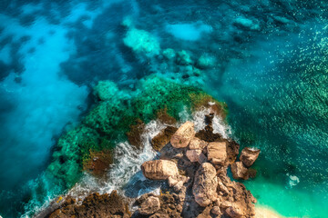 Canvas Print - Summer holiday background. Aerial view of seascape with a beautiful stone coastline. Sea coast with blue, turquoise clear water on a sunny day